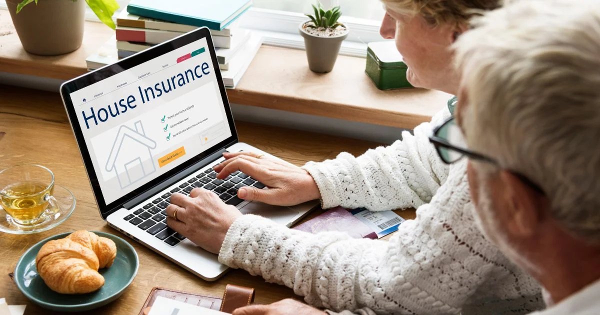 Senior couple reviewing house insurance policy on laptop at home