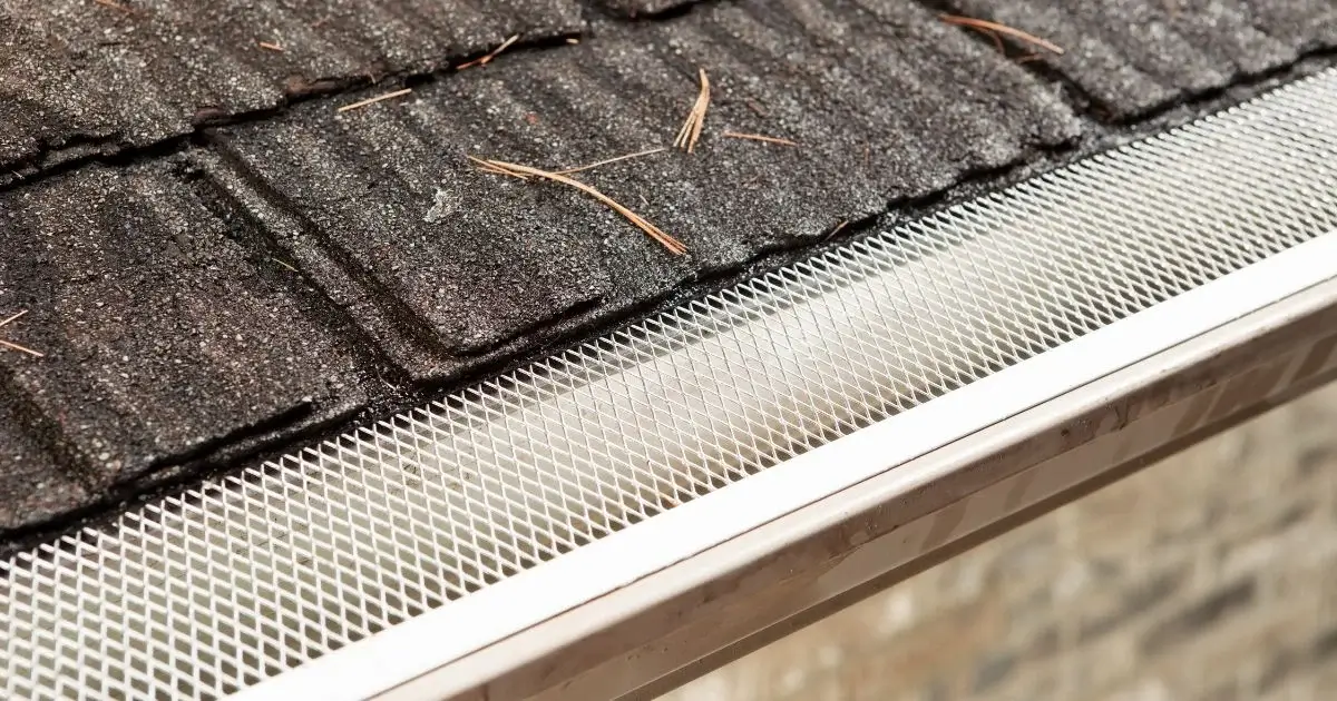 Metal gutter guard preventing leaves and debris buildup